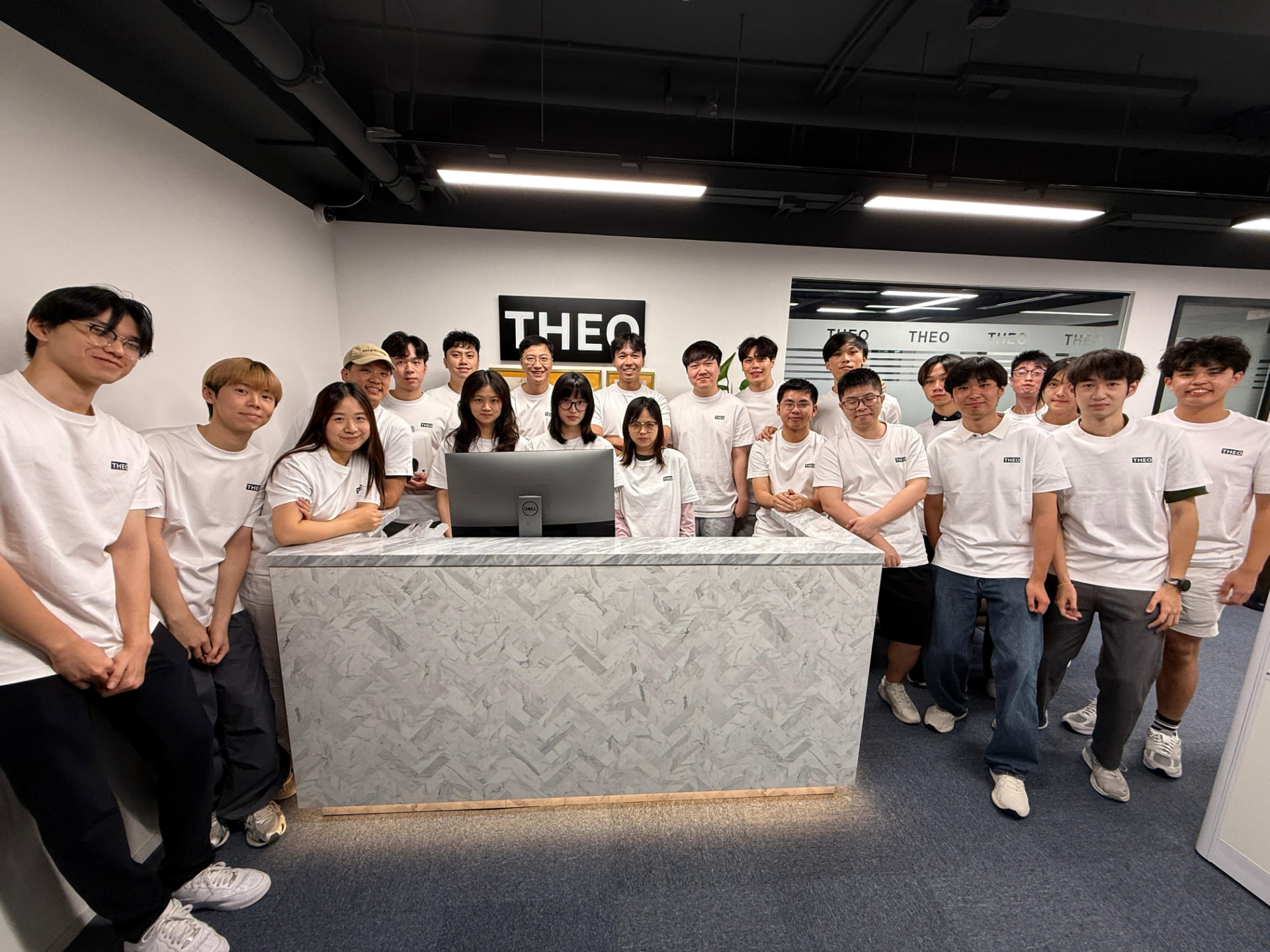 The first cohort of Theo Quant summer interns and team members photographed together at the firm's Hong Kong office.
